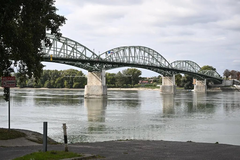 The Maria Valeria Bridge is pictured following a ceremony to celebrate the bridge's 130th anniversary, near the countries' common border in Esztergom, Hungary on September 28, 2025. The bridge links the Slovak town of Sturovo with the Hungarian town of Esztergom across the Danube river. It was opened on September 28, 1895. (Photo by Attila KISBENEDEK / AFP)