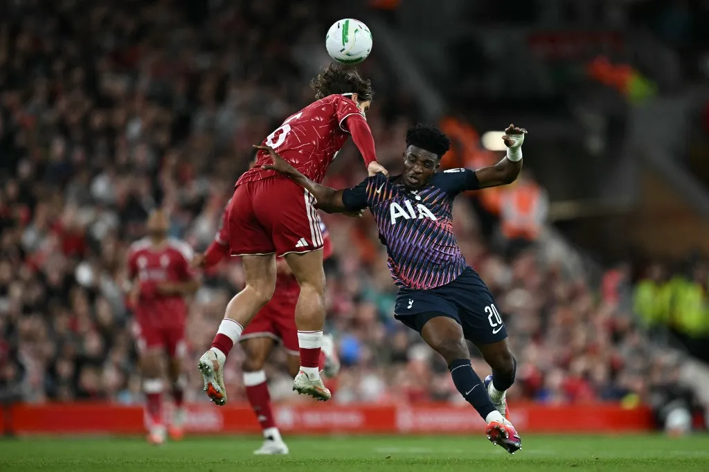 Liverpool's Hungarian defender #06 Milos Kerkez battles for the ball with Tottenham Hotspur's Ghanian striker #20 Mohammed Kudus during the English League Cup third round football match between Liverpool and Tottenham Hotspur at Anfield stadium in Liverpool, north west England on September 15, 2026. (Photo by Paul ELLIS / AFP) / RESTRICTED TO EDITORIAL USE. No use with unauthorized audio, video, data, fixture lists, club/league logos or 'live' services. Online in-match use limited to 120 images. An additional 40 images may be used in extra time. No video emulation. Social media in-match use limited to 120 images. An additional 40 images may be used in extra time. No use in betting publications, games or single club/league/player publications. /