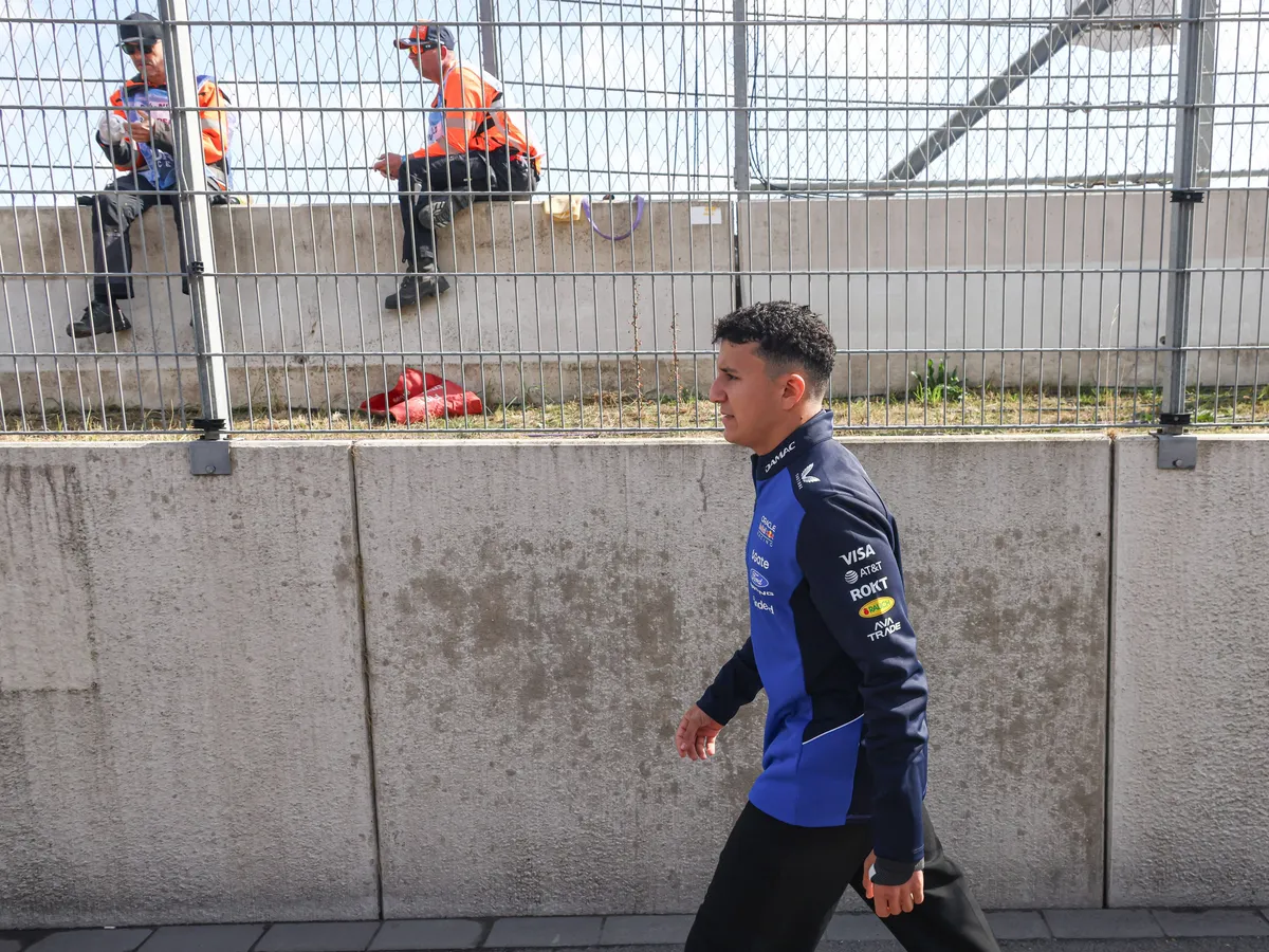 Isack Hadjar of France walking behind the pit lane with his hand visible injured. The hand seems visibly wrapped in bandage following his injury, ahead of the Dutch Grand Prix at circuit Zandvoort, a racetrack near Amsterdam. Hadjar drives the F1 race car No 6, the Red Bull RB22 for the Oracle Red Bull Racing team has been temporarily replaced by Liam Lawson. Zandvoort, the Netherlands on August 22, 2026. (Photo by Nicolas Economou/NurPhoto) (Photo by Nicolas Economou / NurPhoto via AFP)
