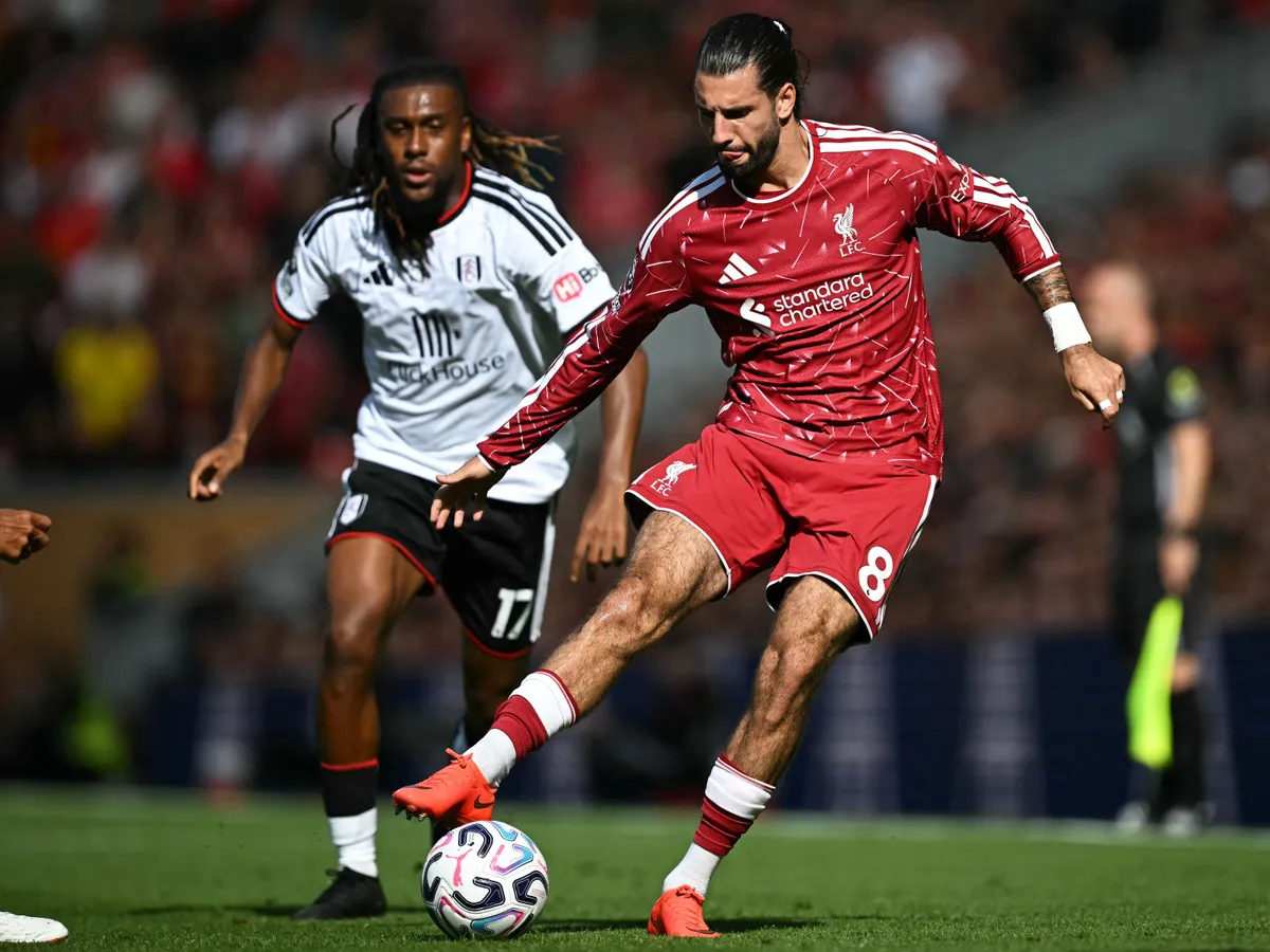 Liverpool's Hungarian midfielder #08 Dominik Szoboszlai (R) controls the ball during the English Premier League football match between Liverpool and Fulham at Anfield in Liverpool, north west England on September 12, 2026. (Photo by Paul ELLIS / AFP) / RESTRICTED TO EDITORIAL USE. No use with unauthorized audio, video, data, fixture lists, club/league logos or 'live' services. Online in-match use limited to 120 images. An additional 40 images may be used in extra time. No video emulation. Social media in-match use limited to 120 images. An additional 40 images may be used in extra time. No use in betting publications, games or single club/league/player publications. / 