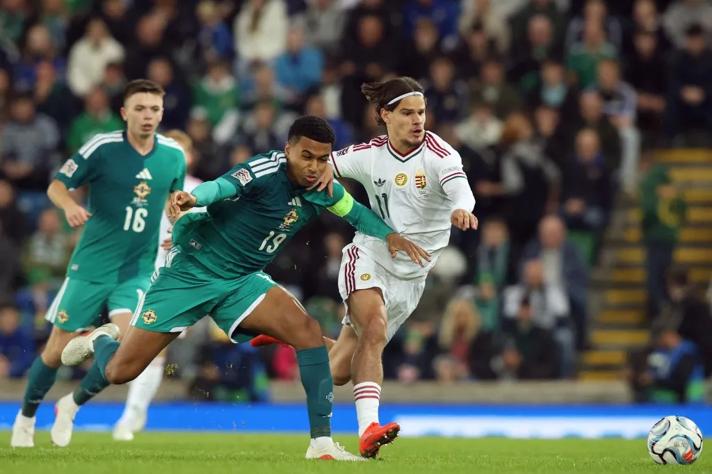 Northern Ireland's defender #19 Shea Charles (L) vies with Hungary's defender #11 Milos Kerkez (R) during the UEFA Nations League, League B, Group 2 match between Northern Ireland and Hungary at Windsor Park in Belfast, Northern Ireland on September 28, 2026. (Photo by Paul Faith / AFP) / The erroneous mention[s] appearing in the metadata of this photo by Paul Faith has been modified in AFP systems in the following manner: [Northern Ireland] instead of [Republic of Ireland]. Please immediately remove the erroneous mention[s] from all your online services and delete it (them) from your servers. If you have been authorized by AFP to distribute it (them) to third parties, please ensure that the same actions are carried out by them. Failure to promptly comply with these instructions will entail liability on your part for any continued or post notification usage. Therefore we thank you very much for all your attention and prompt action. We are sorry for the inconvenience this notification may cause and remain at your disposal for any further information you may require.
