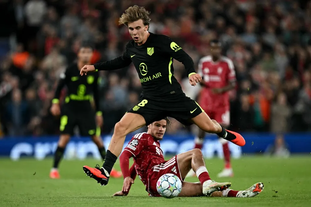 Atletico Madrid's Spanish midfielder #08 Pablo Barrios jumps over Liverpool's Hungarian defender #06 Milos Kerkez during the UEFA Champions League football match between Liverpool and Atletico Madrid at Anfield in Liverpool, north west England on September 9, 2026. (Photo by Paul ELLIS / AFP)
