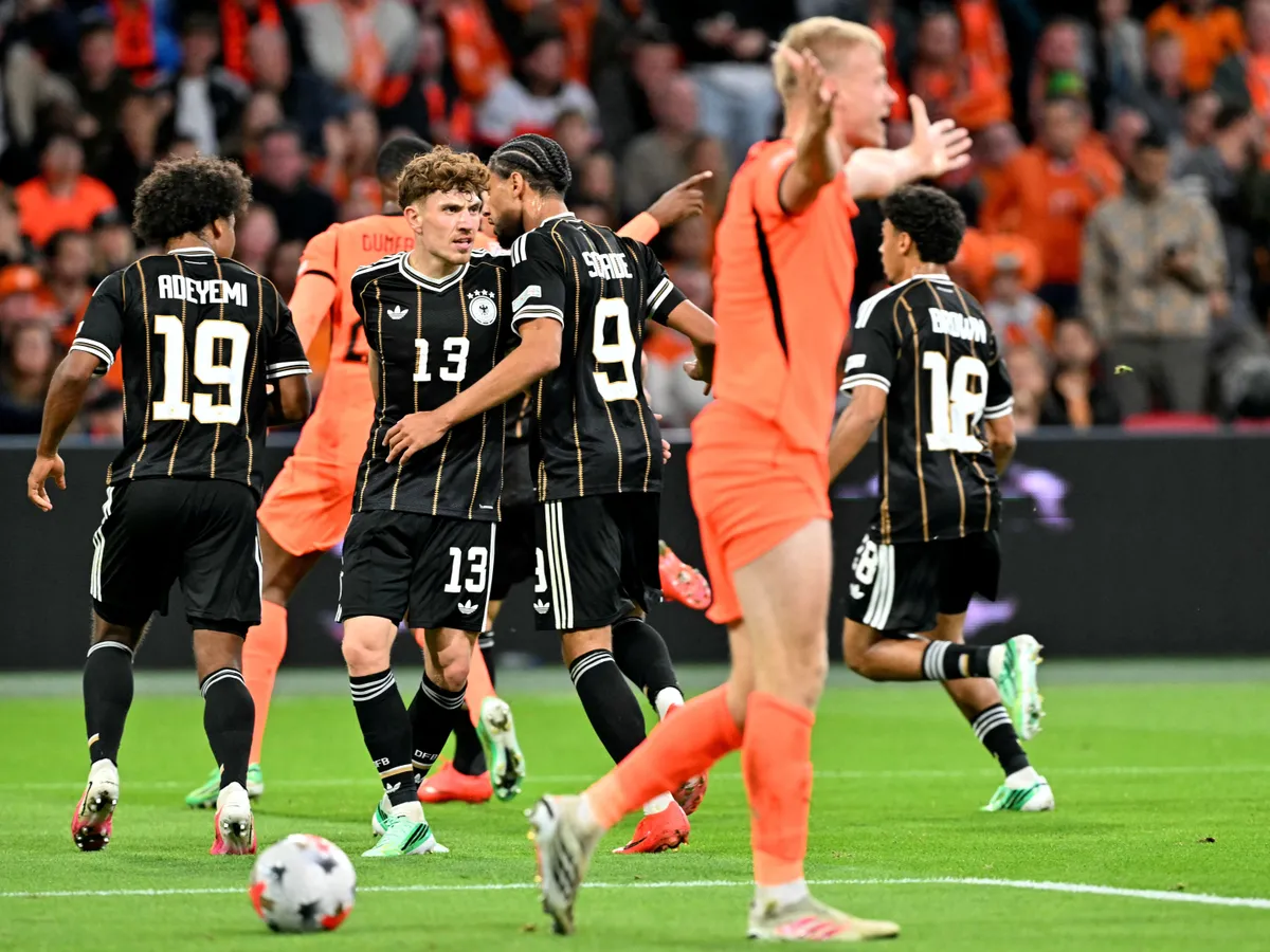 Germany's players celebrate after scoring their team's first goal during the UEFA Nations League (League A, Group A2) football match between Netherlands and Germany at Johan Cruijff ArenA in Amsterdam on September 24, 2026. (Photo by NICOLAS TUCAT / AFP)