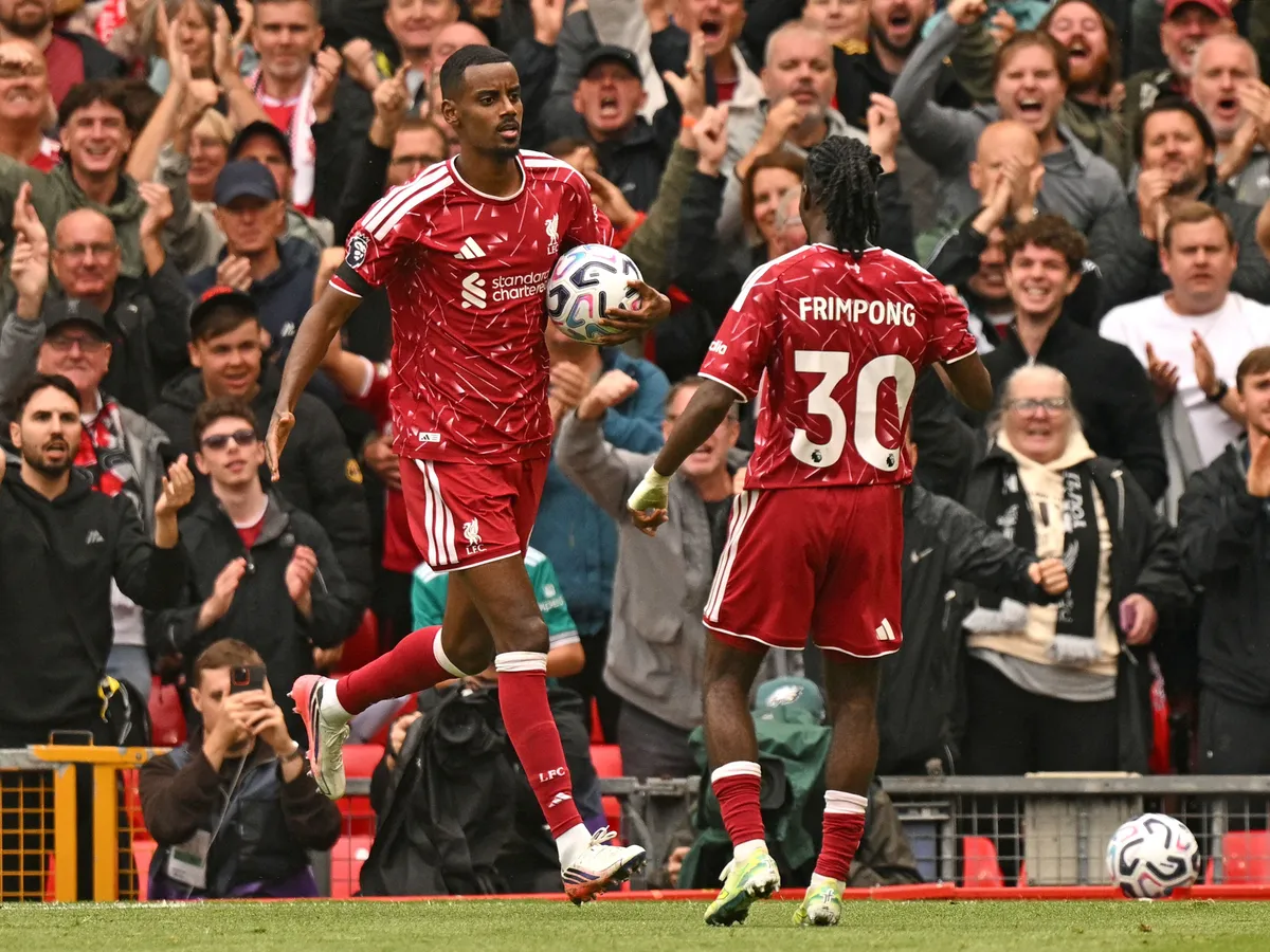 Liverpool's Swedish striker #09 Alexander Isak (L) celebrates with Liverpool's Dutch defender #30 Jeremie Frimpong after scoring the team's first goal during the English Premier League football match between Liverpool and Nottingham Forest at Anfield in Liverpool, north west England on August 29, 2026. (Photo by Oli SCARFF / AFP) / RESTRICTED TO EDITORIAL USE. No use with unauthorized audio, video, data, fixture lists, club/league logos or 'live' services. Online in-match use limited to 120 images. An additional 40 images may be used in extra time. No video emulation. Social media in-match use limited to 120 images. An additional 40 images may be used in extra time. No use in betting publications, games or single club/league/player publications. /