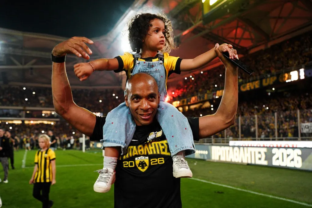 Joao Mario celebrates AEK's Greek Super League title at Allwyn Arena on May 10, 2026, alongside his child. (Photo by Giorgos Arapekos/NurPhoto) (Photo by Giorgos Arapekos / NurPhoto via AFP)