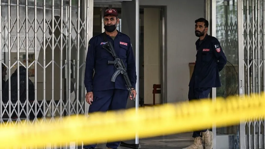 Security personnel stand guard at the entrance of the Mother and Child Health ward following a fire at the Pakistan Institute of Medical Sciences (PIMS) Hospital in Islamabad on August 30, 2026. Pakistan's prime minister said eight officials were suspended and called for criminal proceedings against them, after 14 infants were killed in a fire in the maternity ward of a hospital in the country's capital. (Photo by Aamir QURESHI / AFP)