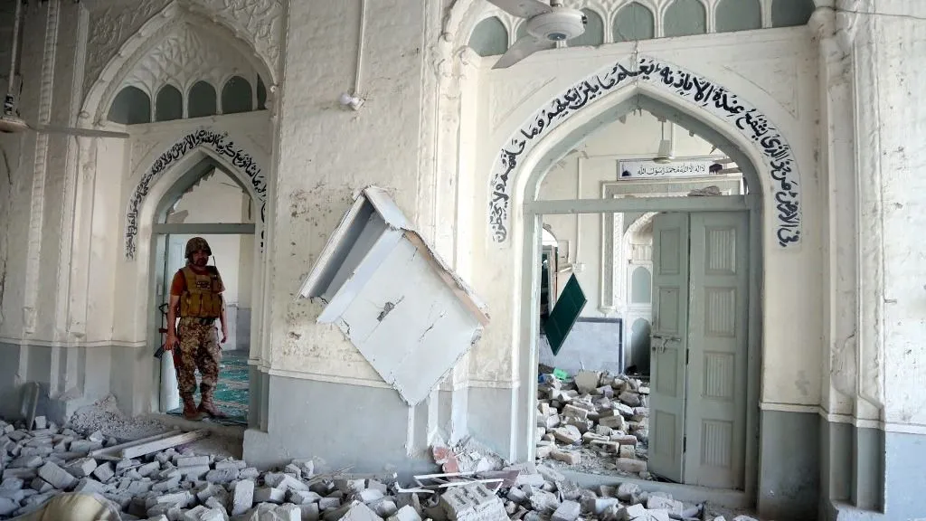 KHYBER PAKHTUNKWA, PAKISTAN - SEPTEMBER 18: Security officials inspect the site of a blast at a mosque near the Old Police Lines in Kohat district of Khyber Pakhtunkhwa province, Pakistan, on September 18, 2026. At least 16 people, including 11 civilians and five police officers, were killed and over 50 others wounded in a suspected suicide bombing targeting a police compound in northwestern Pakistan during Friday congregational prayers, officials said. The casualties occurred when an explosives-laden vehicle rammed into the Old Police Lines gate in Kohat district of Khyber Pakhtunkhwa province, a senior police official said, according to local broadcaster Geo News. Kohat District Hospital's top official, Tahir Ali Shah, confirmed that 15 bodies were brought to the health facility, besides wounded people. Khyber Pakhtunkhwa police identified the deceased as 11 civilians and five police officers. Police said six 'terrorists,' including a suicide bomber, were also killed in the explosion. Hussain Ali / Anadolu (Photo by Hussain Ali / Anadolu via AFP)