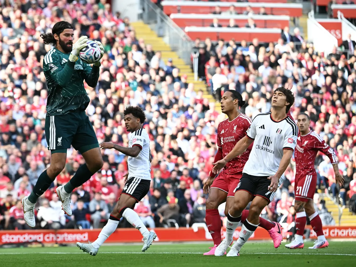Liverpool's Brazilian goalkeeper #01 Alisson Becker saves a shot during the English Premier League football match between Liverpool and Fulham at Anfield in Liverpool, north west England on September 12, 2026. (Photo by Paul ELLIS / AFP) / RESTRICTED TO EDITORIAL USE. No use with unauthorized audio, video, data, fixture lists, club/league logos or 'live' services. Online in-match use limited to 120 images. An additional 40 images may be used in extra time. No video emulation. Social media in-match use limited to 120 images. An additional 40 images may be used in extra time. No use in betting publications, games or single club/league/player publications. /