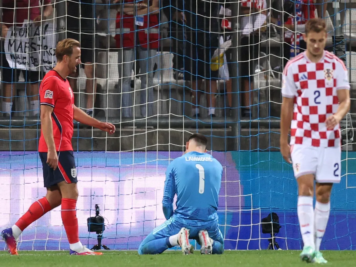 England's forward #9 Harry Kane (L) reacts after scoring his team's fifth goal as Croatia's goalkeeper #1 Dominik Livakovic takes to his knees, during the UEFA Nations League, league A day 3: Group 3, football match between Croatia and England at the Stadion HNK Rijeka stadium in Rijeka, Croatia, on October 3, 2026. (Photo by MARKO PERKOV / AFP)