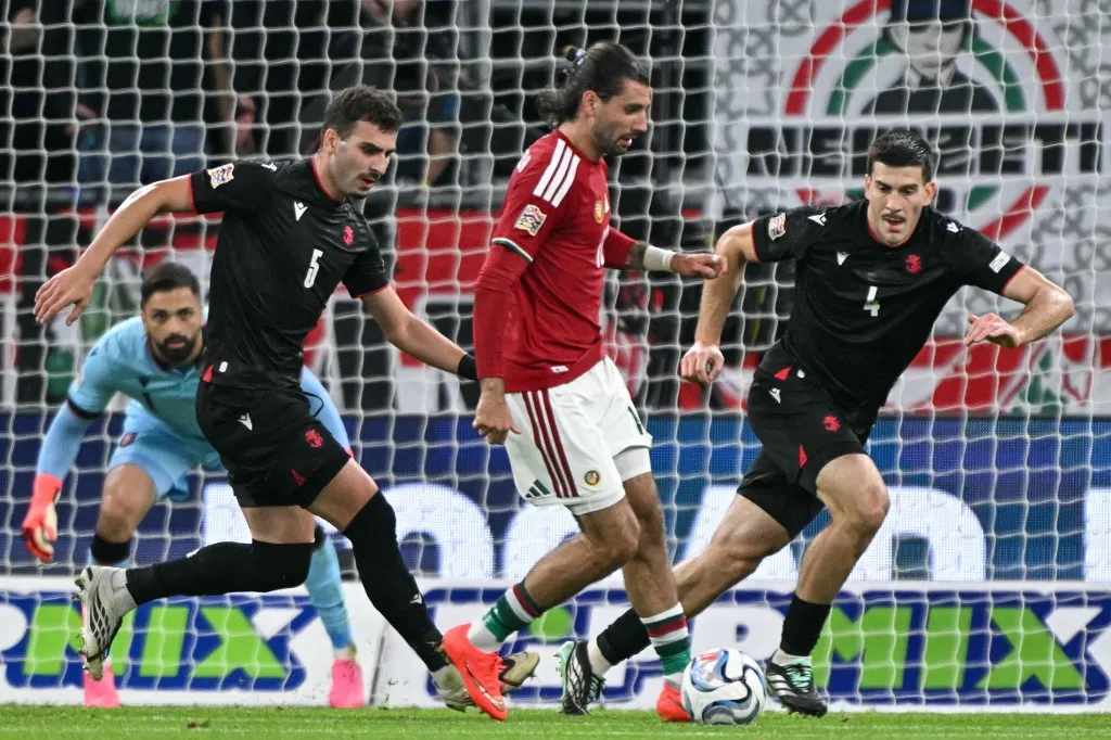 Hungary's midfielder #10 Dominik Szoboszlai (C), Georgia's defender #04 Luka Lochoshvili (R) and Georgia's defender #05 Saba Goglichidze vie for the ball during the UEFA Nations League Group B2 football match between Hungary and Georgia at the Puskas Arena in Budapest, Hungary on October 2, 2026. (Photo by Attila KISBENEDEK / AFP)