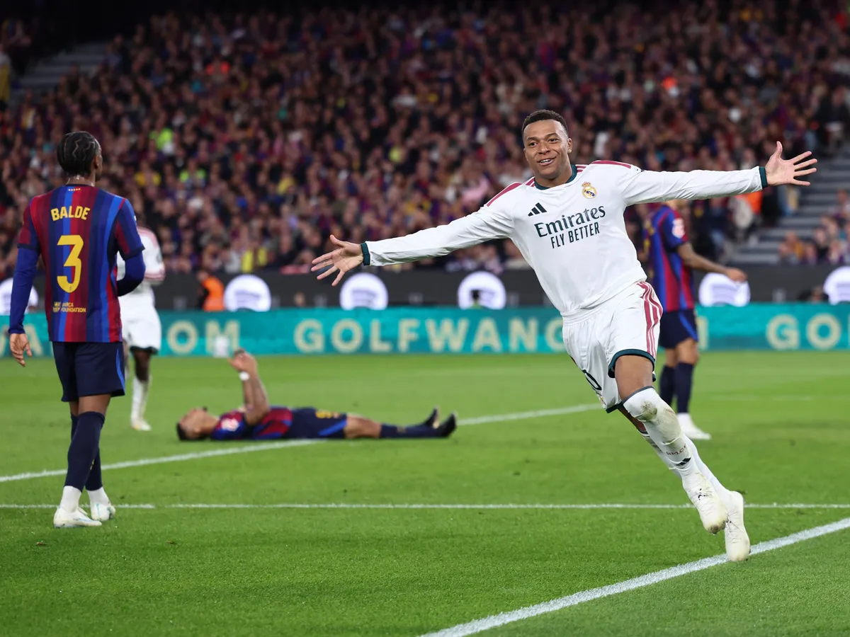 Real Madrid's French forward #10 Kylian Mbappe celebrates scoring his team's second goal during the Spanish league football match between FC Barcelona and Real Madrid CF at Camp Nou Stadium in Barcelona on October 25, 2026. (Photo by Josep LAGO / AFP)