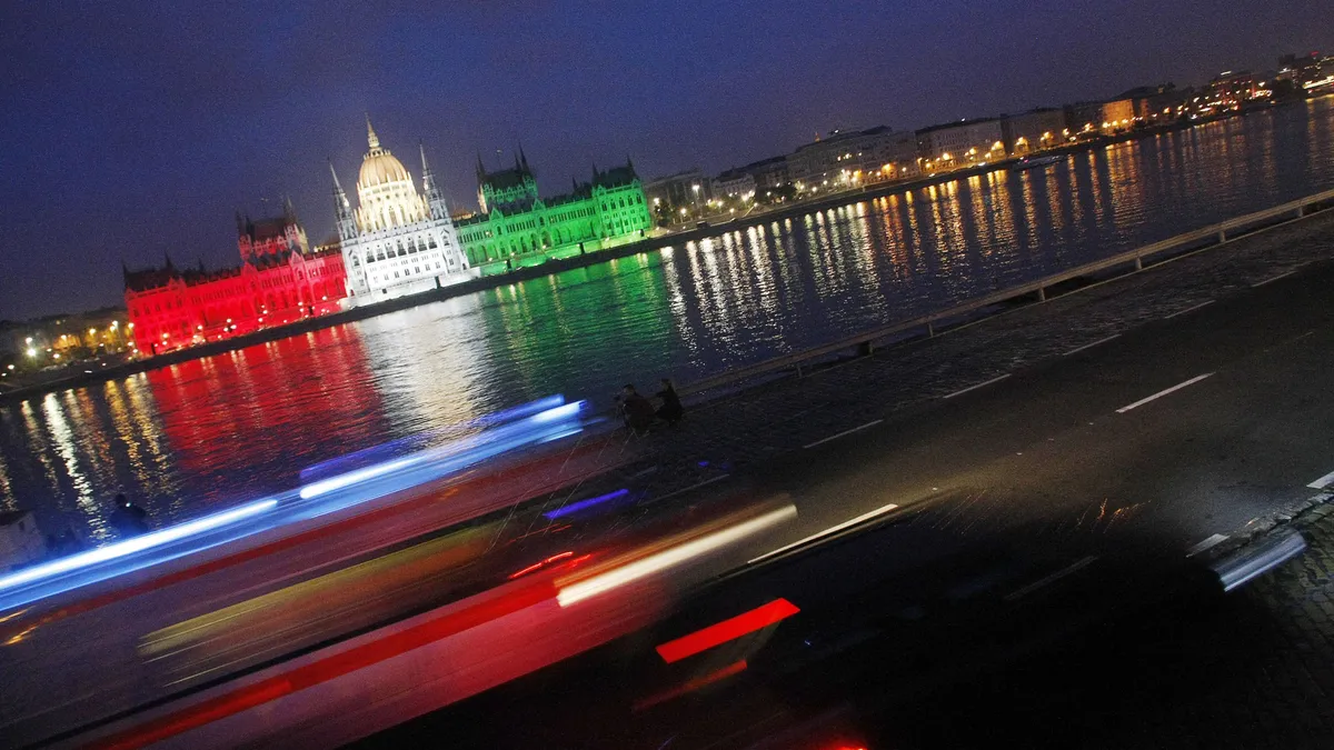 október 23, The building of the Hungarian Parliament is lighted by national tricolor lights to commemorate the 1956 uprising against Soviet occupation during the national day on the bank of the river Danube in downtown Budapest, on October 23, 2009. Hungary's uprising which erupted on October 23, 1956 and was crushed by Soviet tanks on November 4, sealing the country's fate as a satellite state of Moscow until the fall of the Iron Curtain in 1989. AFP PHOTO / FERENC ISZA (Photo by FERENC ISZA / AFP)