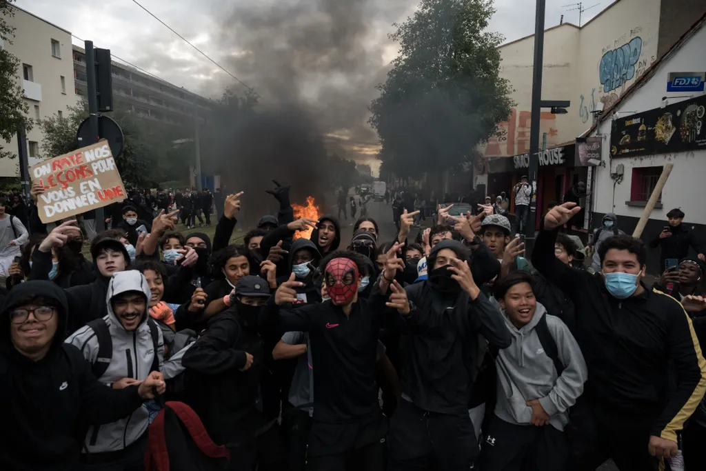 Középiskolás diákok gesztikulálnak a háttérben égő tűzzel, miközben középiskolás diákok vesznek részt egy tüntetésen a Lycée Deodat középiskola közelében, Toulouse-ban, Délnyugat-Franciaországban, 2026. október 1-jén. Szeptember vége óta a diákok tüntetés