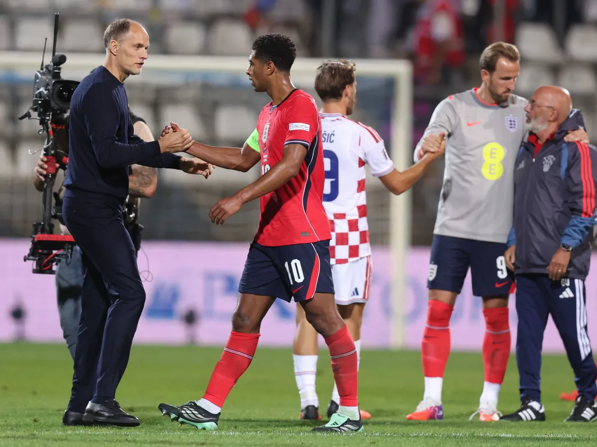 England's head coach Thomas Tuchel congratulates England's midfielder #10 Jude Bellingham after the UEFA Nations League, league A day 3: Group 3, football match between Croatia and England at the Stadion HNK Rijeka stadium in Rijeka, Croatia, on October 3, 2026. (Photo by MARKO PERKOV / AFP)
