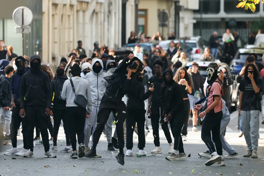 Diákok dobálnak tárgyakat, miközben tiltakozó diákok blokádot hajtanak végre a Place de la Nation közelében, Párizsban, 2026. október 2-án. Szeptember vége óta a diákok tüntetéseket szerveznek iskolák előtt a sérelmek miatt, az órarendektől, az osztálylét