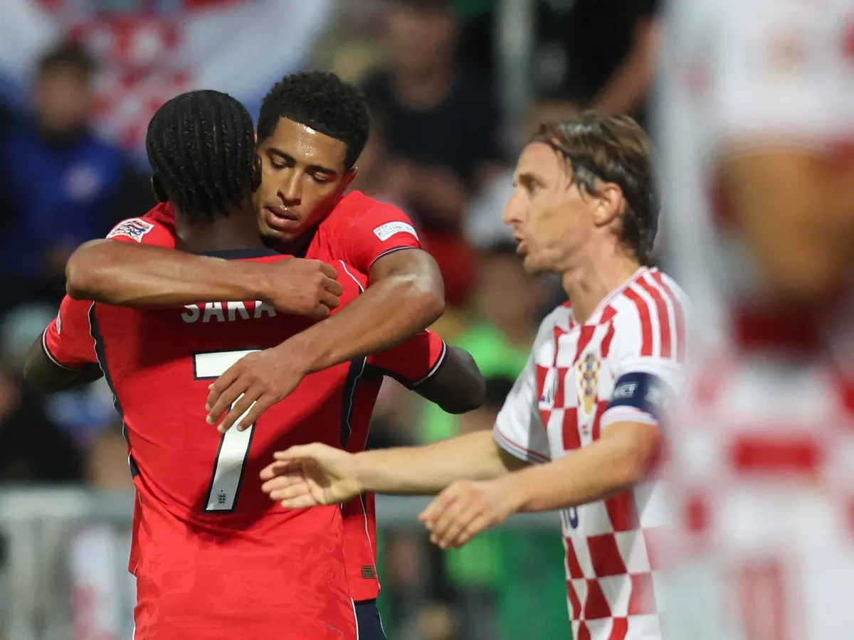 England's midfielder #10 Jude Bellingham celebrates with teammate England's forward #7 Bukayo Saka after he scored England's fourth goal, as Croatia's midfielder #10 Luka Modric (R) reacts during the UEFA Nations League, league A day 3: Group 3, football match between Croatia and England at the Stadion HNK Rijeka stadium in Rijeka, Croatia, on October 3, 2026. (Photo by MARKO PERKOV / AFP)