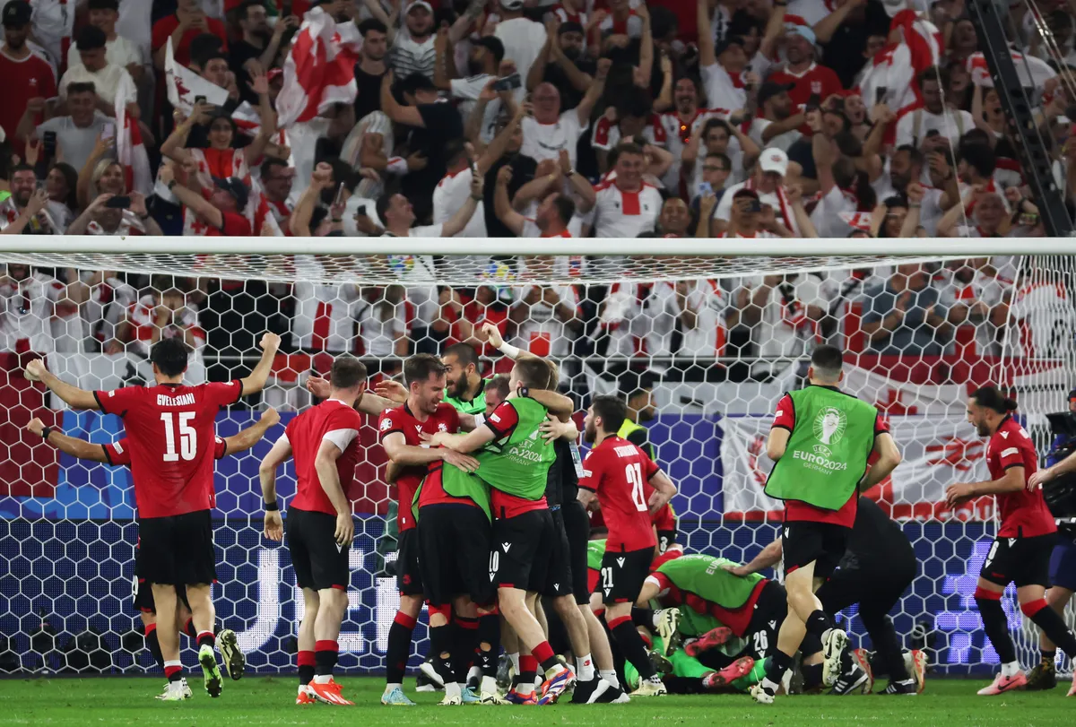 (240627) -- GELSENKIRCHEN, June 27, 2024 (Xinhua) -- Team Georgia celebrate their victory after the UEFA Euro 2024 Group F match between Portugal and Georgia in Gelsenkirchen, Germany on June 26, 2024. (Xinhua/Zhang Fan) Xinhua News Agency / eyevine  Contact eyevine for more information about using this image: T: +44 (0) 20 8709 8709 E: info@eyevine.com http://www.eyevine.com