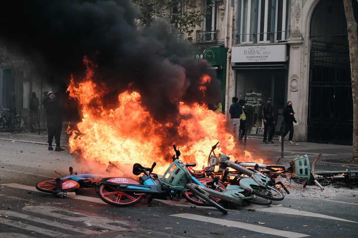 Bicycles are set on fire to serve as barricades during an anti-government protest, marking the return of the ''Yellow Vests'' in Paris, France, on October 17, 2026. (Photo by Vincent Koebel/NurPhoto) (Photo by Vincent Koebel / NurPhoto via AFP)