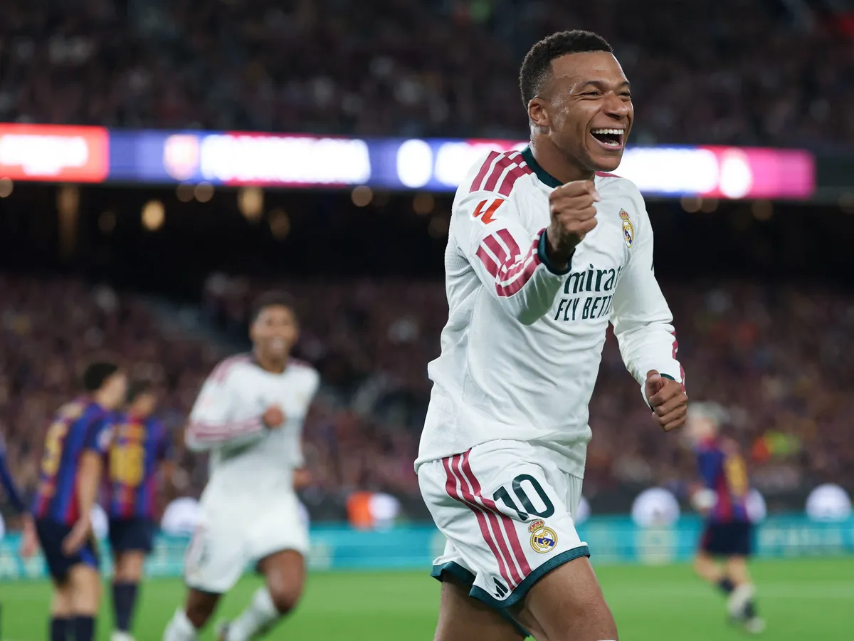 Real Madrid's French forward #10 Kylian Mbappe celebrates scoring his team's first goal during the Spanish league football match between FC Barcelona and Real Madrid CF at Camp Nou Stadium in Barcelona on October 25, 2026. (Photo by Lluis GENE / AFP)