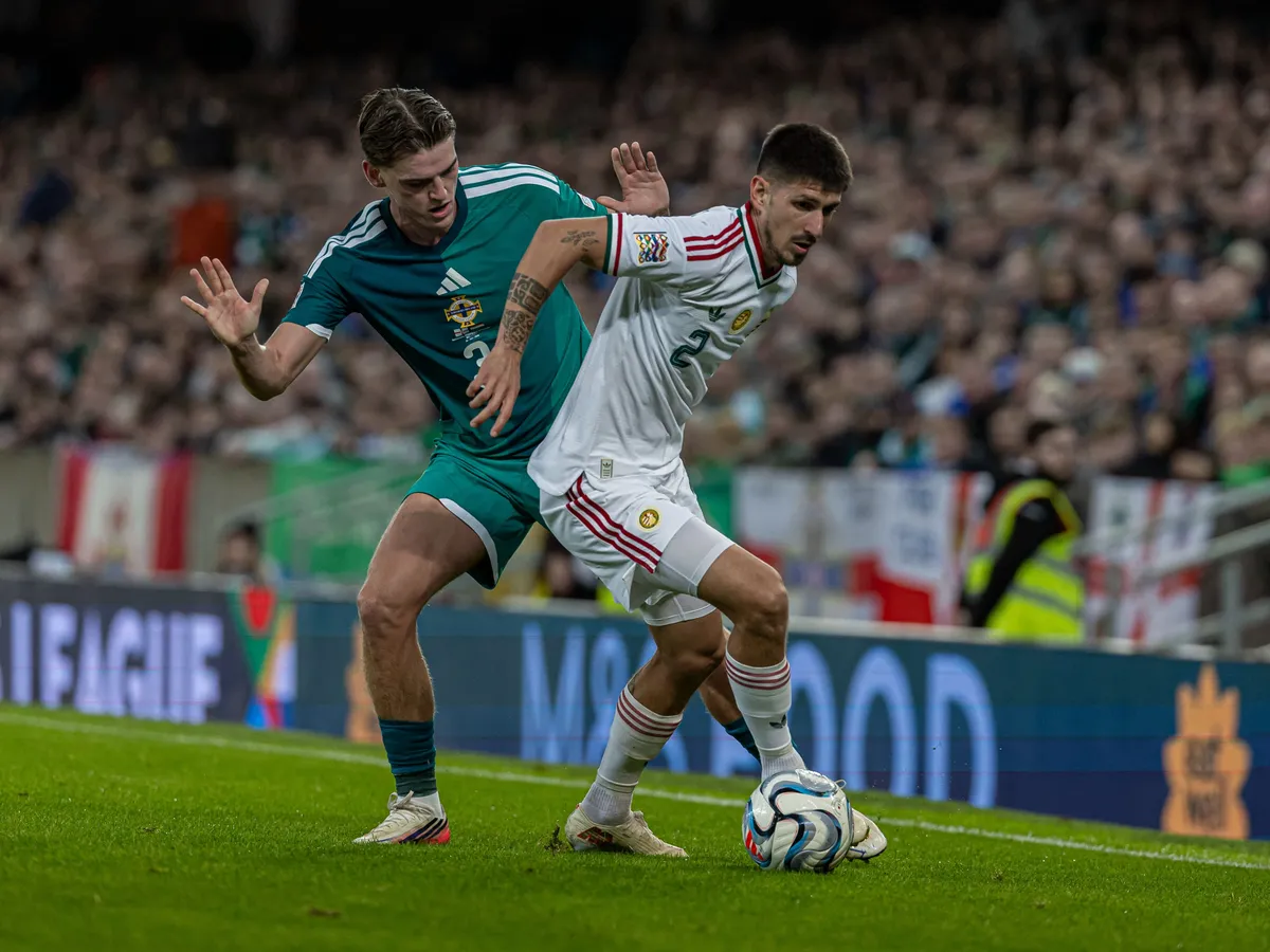 Attila Osvath of Hungary competes for the ball with Justin Devenny of Northern Ireland during the UEFA Nations League match at Windsor Park in Belfast, on September 28, 2026. (Photo by Robert Szaniszlo/NurPhoto) (Photo by Robert Szaniszlo / NurPhoto via AFP)