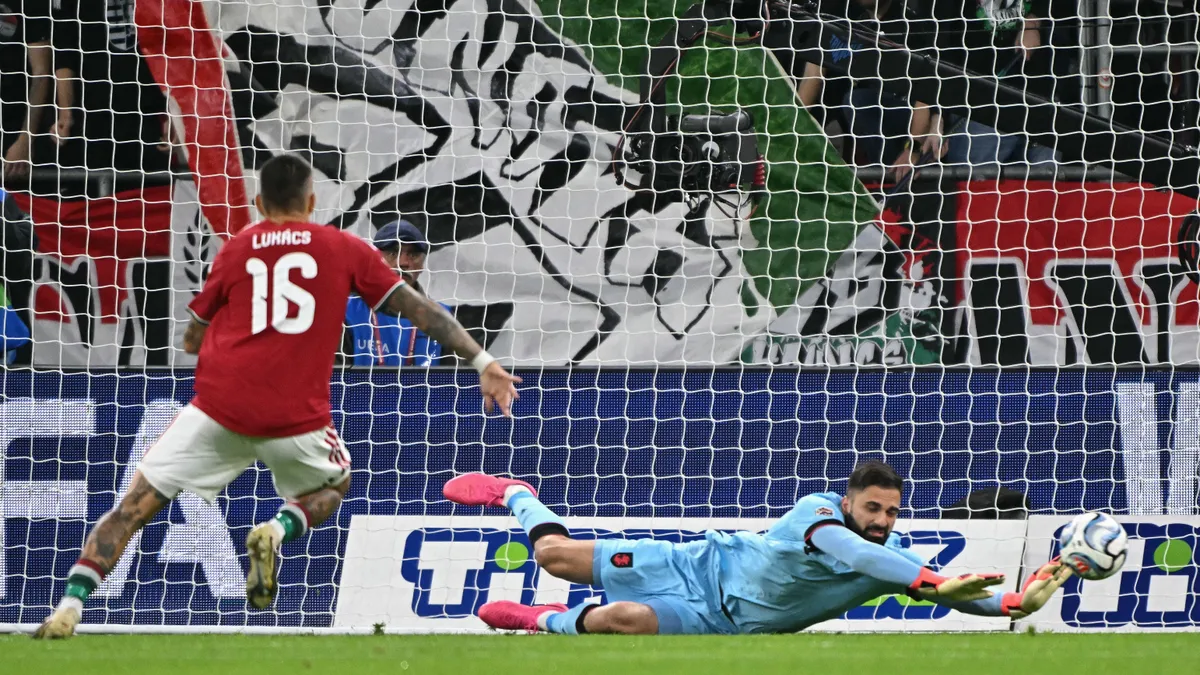 Georgia's goalkeeper #01 Giorgi Mamardashvili (R) gets down to save a shoot on goal during the UEFA Nations League Group B2 football match between Hungary and Georgia at the Puskas Arena in Budapest, Hungary on October 2, 2026. (Photo by Attila KISBENEDEK / AFP)